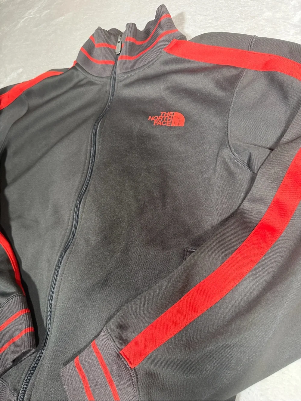 The North Face Black Jacket with Red Stripe Accents